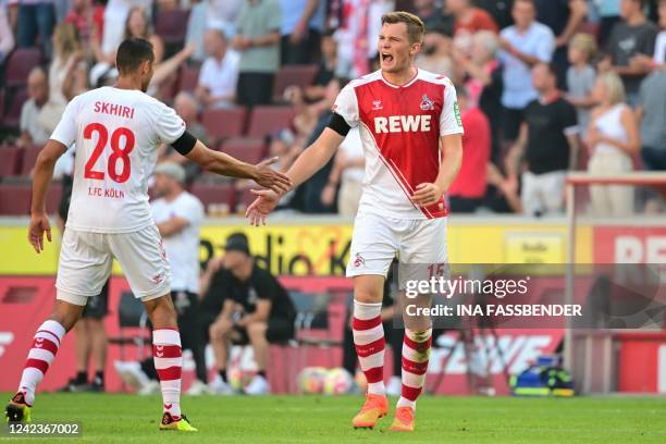 Cologne's German defender Luca Kilian celebrates scoring the opening goal with his teammate Cologne's Tunisian midfielder Ellyes Skhiri during the...