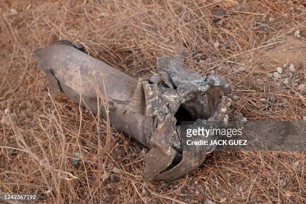 This picture shows the remains of a rocket launched from the Gaza Strip in the southern Israeli city of Ashkelon on August 7, 2022. - Israel agreed...