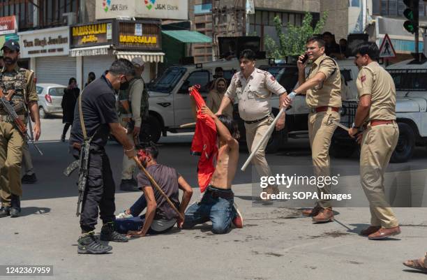 Indian policemen detain Shia Muslim mourners during a religious procession on the 8th day of Muharram. Authorities imposed strict restrictions in...