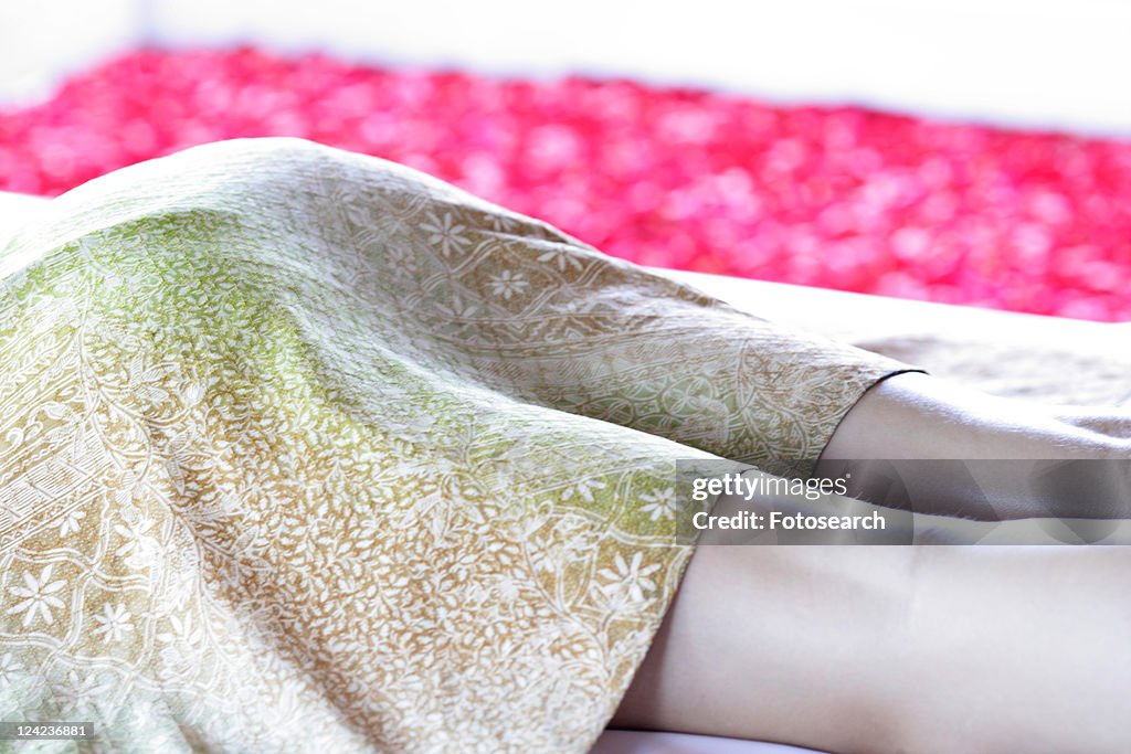 A woman lying on massage table.