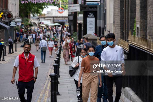 People wearing face masks to protect against Coronavirus / Covid-19 on 22nd July 2022 in London, United Kingdom. Despite the wearing of face...