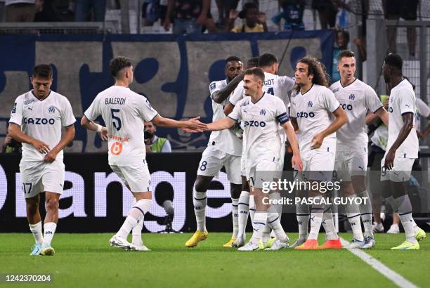 Marseille's players celebrate after scoring a goal during the French L1 football match between Olympique Marseille and Stade de Reims at Stade...