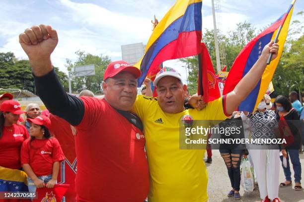 Venezuelan and a Colombian man embrace each other at the Simon Bolivar International bridge between Colombia and Venezuela in Cucuta, Colombia, on...