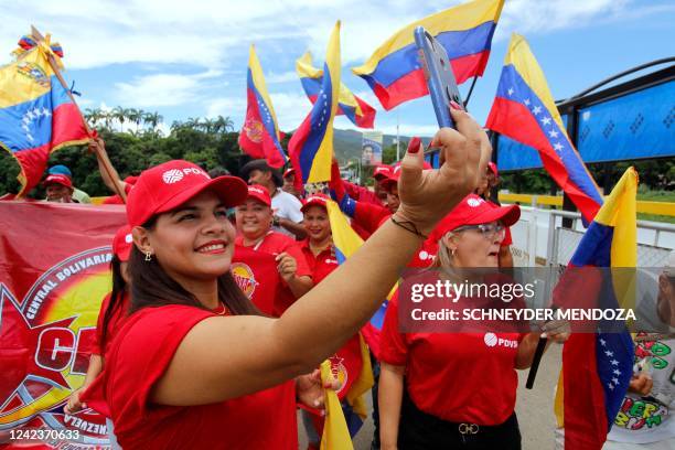 Venezuelans wait in front of big screens for the inauguration ceremony of the Colombian President-elect Gustavo Petro at the Simon Bolivar...