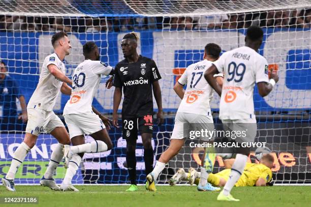 Marseille's palyers celebrate after scoring a goal during the French L1 football match between Olympique Marseille and Stade de Reims at Stade...