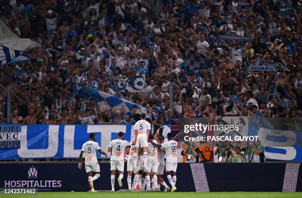 Marseille's players celebrate in front of their fans after scoring a goal during the French L1 football match between Olympique Marseille and Stade...