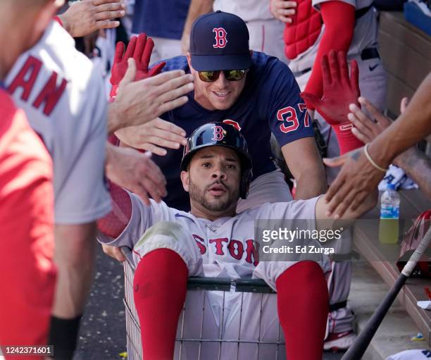 Tommy Pham of the Boston Red Sox is pushed in a cart by Nick Pivetta after hitting a two-run home run in the seventh inning against the Kansas City...