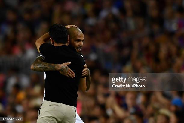 Dani Alves of Pumas and Xavi Hernandez head coach of Barcelona greets each other during the Joan Gamper Trophy, friendly presentation match between...