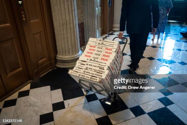 Staffers wheel pizza to The Lyndon Baines Johnson Room off the Senate Chamber before final passage of the Inflation Reduction Act at the U.S. Capitol...