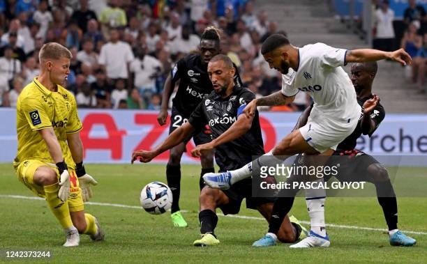 Marseille's Colombian forward Luis Suarez kicks the ball as Reims' Austrian goalkeeper Patrick Pentz goes to block it during the French L1 football...