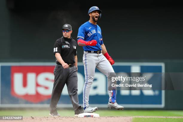 Lourdes Gurriel Jr. #13 of the Toronto Blue Jays celebrates his double against the Minnesota Twins in the tenth inning of the game at Target Field on...