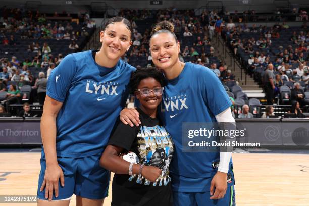 Natalie Achonwa and Kayla McBride of the Minnesota Lynx pose for a photo with a fan before the game against the Atlanta Dream on August 7, 2022 at...