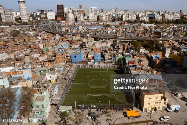 Soccer field is seen at the Villa 31 slum backdropped by office and apartment buildings in Buenos Aires, Argentina August 6, 2022. The country is...