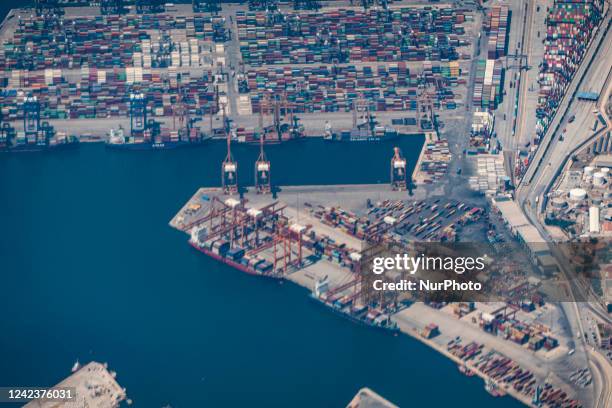 Aerial view from an airplane window of Pireaus port GRPIR. View of large freighter ships, nautical vessels docked while loading - unloading...