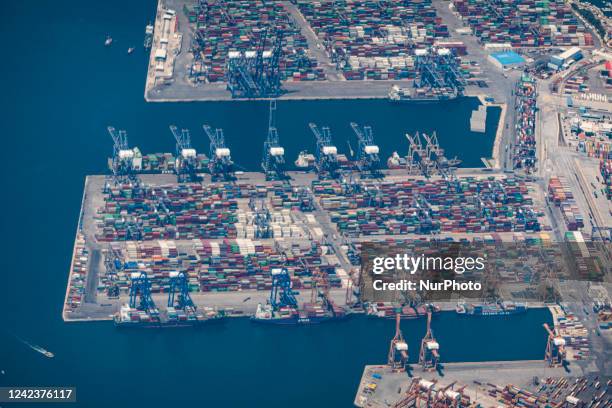 Aerial view from an airplane window of Pireaus port GRPIR. View of large freighter ships, nautical vessels docked while loading - unloading...