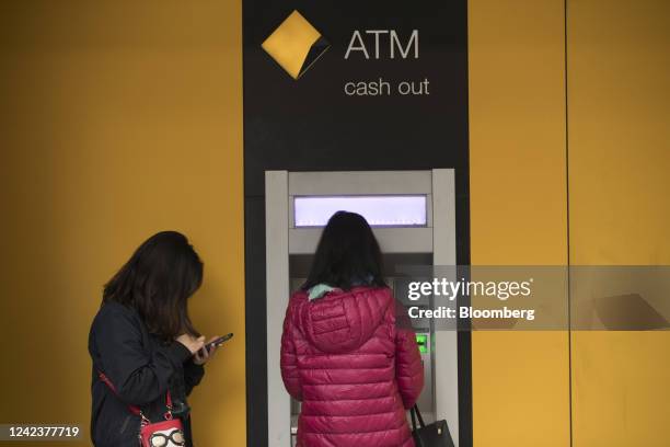 Customers use an automated teller machine outside a Commonwealth Bank of Australia branch in Sydney, Australia, on Friday, Aug. 5, 2022. CBA is...