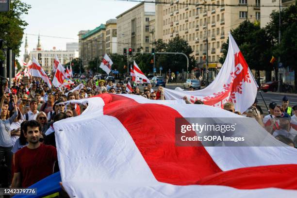 People held a big white-red-white flag while walking along the center of Warsaw during the March of dignity dedicated to the 2nd anniversary of the...