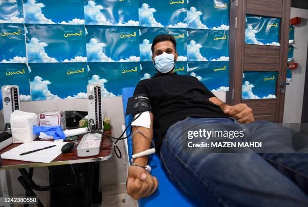 Bahraini Shiite Muslims take part in a blood drive campaign to encourage donating blood instead of self-flagellation with swords to commemorate...