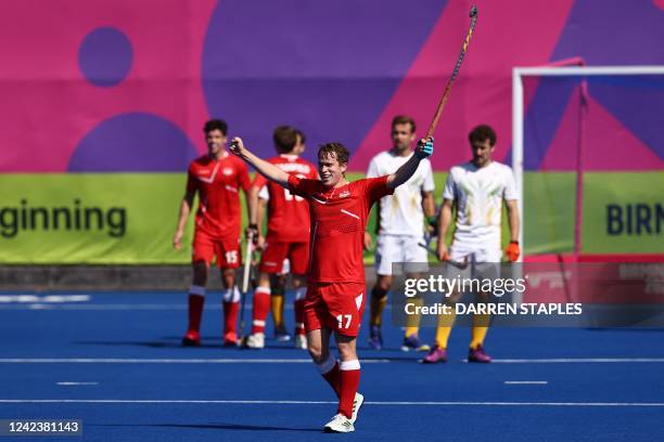 England's Stuart Rushmere celebrates his team's victory at the end of the men's bronze medal hockey match between England and South Africa on day...