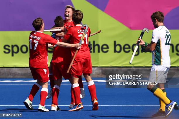 England's players celebrate their win at the end of the men's bronze medal hockey match between England and South Africa on day eleven of the...