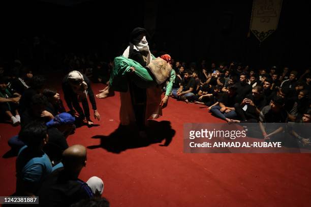 Iraqi Shiite Muslims re-enact historical events during a ritual of mourning in Sadr City in eastern Baghdad late on August 7 to mark Ashura, a 10-day...
