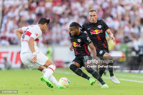 Konstantinos Mavropanos of VfB Stuttgart, Christopher Nkunku of RB Leipzig and David Raum of RB Leipzig #eim Zweikampf during the Bundesliga match...