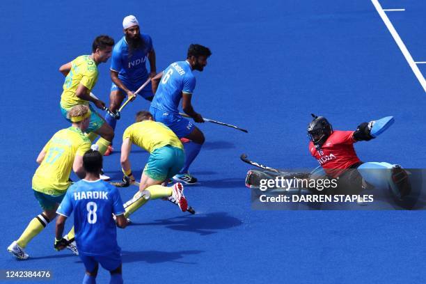 India's Sreejesh Parattu Raveendran saves a shot from Australia's Tom Wickham during the men's bronze medal hockey match between England and South...