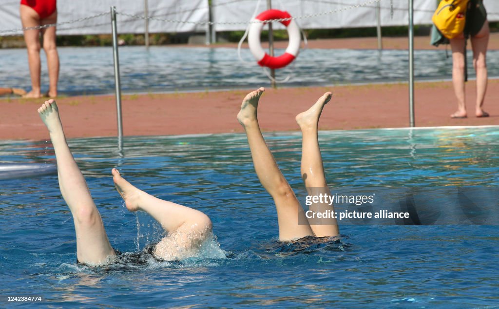 Pool Hand Stand Children do a handstand under water during their vacation at the ...