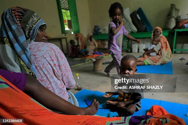 Mothers, who fled the ethnic clashes in Sudan's Blue Nile state, sit with their children at a camp for displaced people in al-Damazin in southeastern...