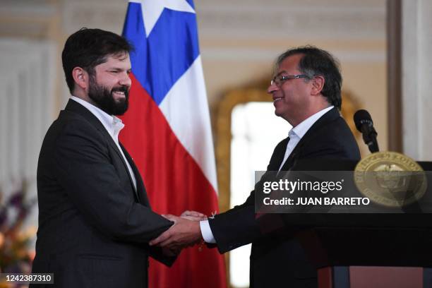 Chilean President Gabriel Boric shakes hands with his Colombian counterpart Gustavo Petro during a press conference in Casa Narino palace in Bogota,...