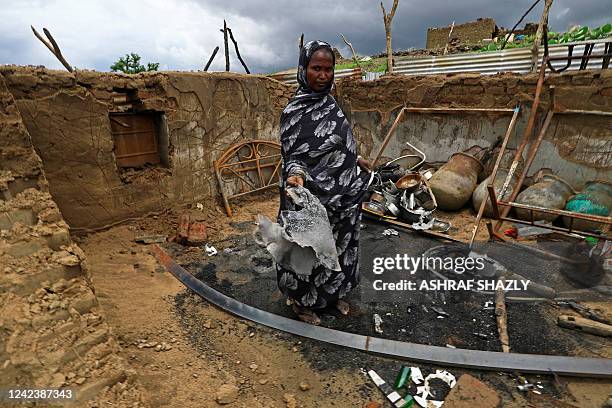 Woman stands inside her damaged house in the aftermath of ethnic clashes in Sudan's Blue Nile state, in the southeastern Sudanese town of Roseires on...