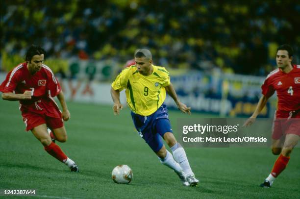 June 2002, Saitama - FIFA World Cup - Brazil v Turkey - Ronaldo of Brazil takes the ball away from Bulent Korkmaz of Turkey.