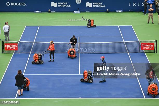 Play is delayed as crews dry centre court prior to Day 3 of the National Bank Open at Stade IGA on August 8, 2022 in Montreal, Canada.