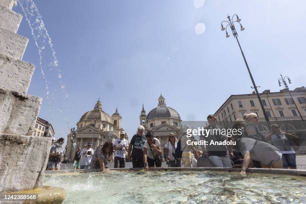 Tourists refresh themselves at a fountain in Piazza del Popolo, Rome, Italy, on August 08, 2022. Italy has been facing an intense heatwave for...