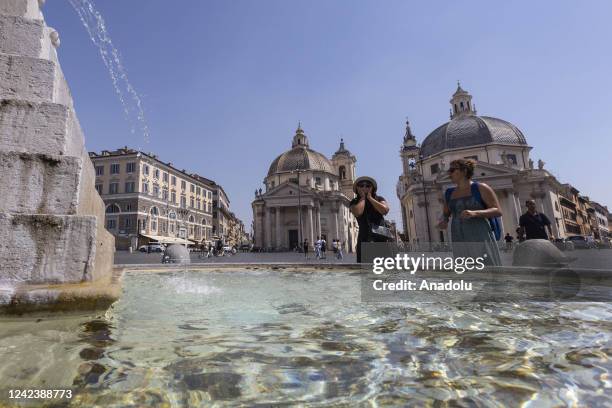 Tourists refresh themselves at a fountain in Piazza del Popolo, Rome, Italy, on August 08, 2022. Italy has been facing an intense heatwave for...