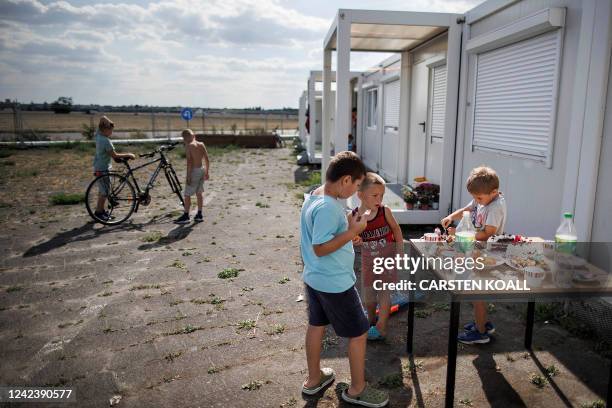 Years old Artem Kozak from Odessa celebrates his birthday with other children in front of the container-accommodations at the former Tempelhof...