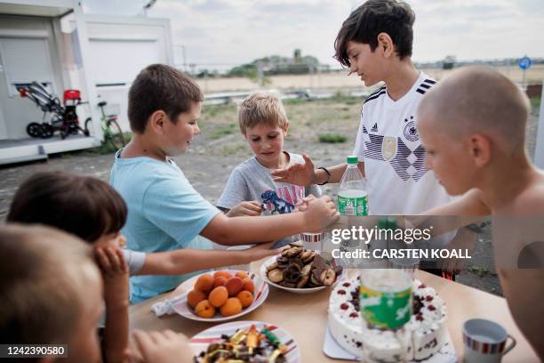 Years old Artem Kozak from Odessa celebrates his birthday with other children in front of the container-accommodations at the former Tempelhof...