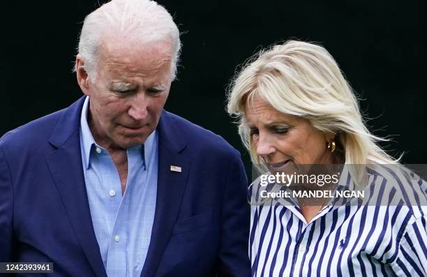 President Joe Biden and US First Lady Jill Biden walk on the South Lawn upon returning to the White House in Washington, DC, on August 8, 2022. - US...