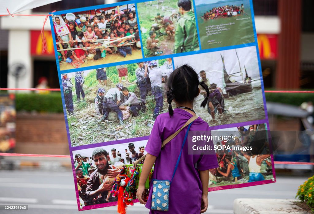 A kid looks at the pictures during the anniversary of the '...