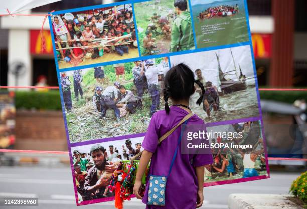 Kid looks at the pictures during the anniversary of the '8888 Uprising' at Tha Phae Gate in Chiang Mai. On the 8th of August, Myanmar commemorated...