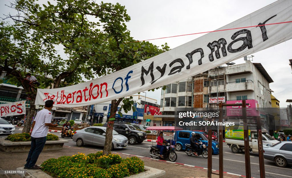 Activists install a banner that says "The Liberation of...