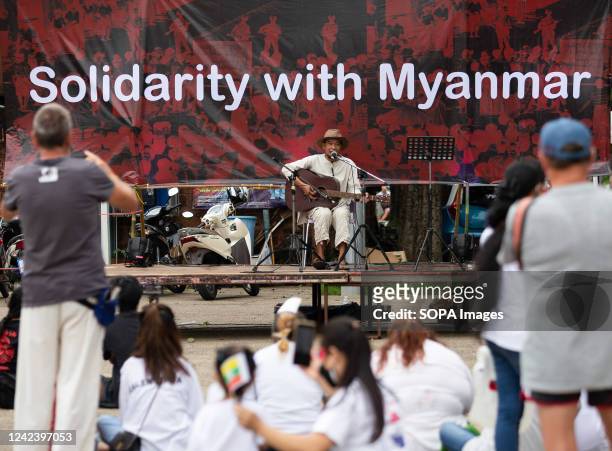 An activist performs music during the anniversary of the '8888 Uprising' at Tha Phae Gate in Chiang Mai. On the 8th of August, Myanmar commemorated...