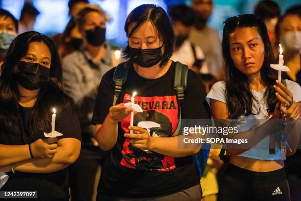 Activists hold a lit candle during the anniversary of the '8888 Uprising' at Tha Phae Gate in Chiang Mai. On the 8th of August, Myanmar commemorated...