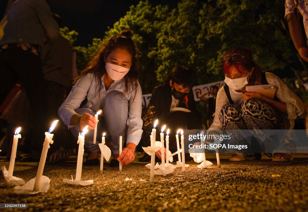 Activists light the candles during the anniversary of the '...