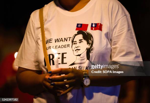 An activist holds a lit candle during the anniversary of the '8888 Uprising' at Tha Phae Gate in Chiang Mai. On the 8th of August, Myanmar...