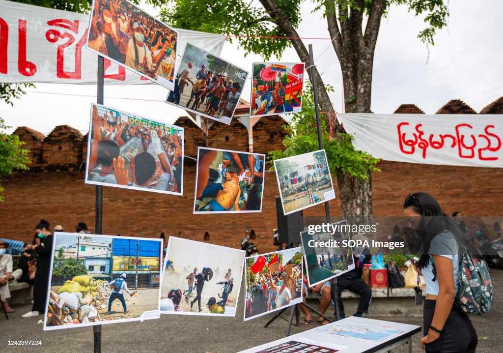 An activist looks at pictures during the anniversary of the...