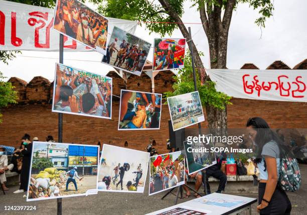 An activist looks at pictures during the anniversary of the '8888 Uprising' at Tha Phae Gate in Chiang Mai. On the 8th of August, Myanmar...