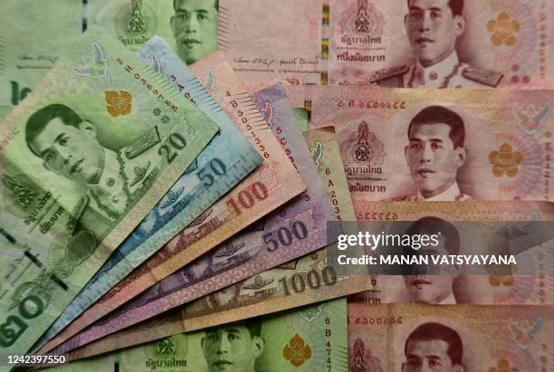 This photo illustration taken in Bangkok on August 9 shows Thai Baht banknotes.