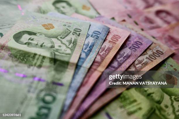 This photo illustration taken in Bangkok on August 9 shows Thai Baht banknotes.