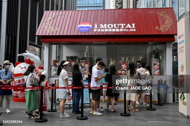 This photo taken on July 13, 2022 shows people waiting to buy Moutai ice cream, made by Chinese liquor brand Kweichow Moutai, at a shopping mall in...